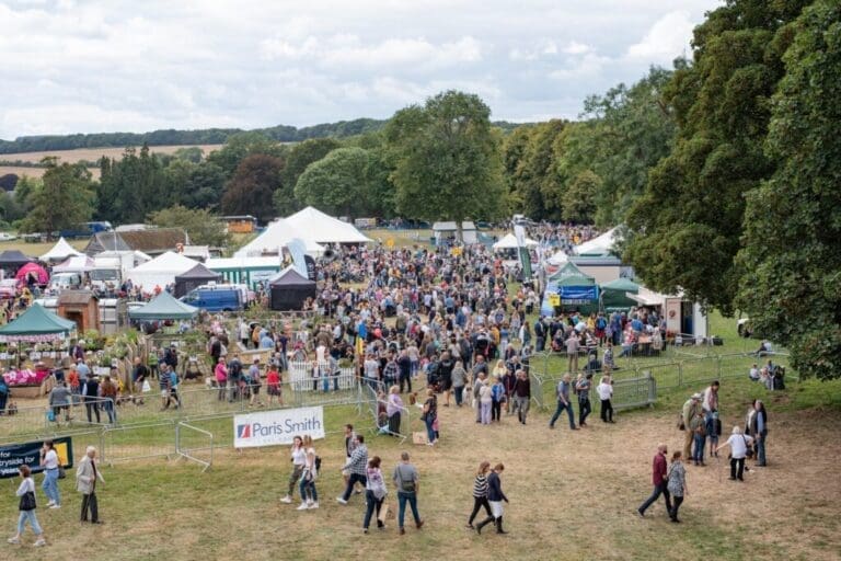 Wide view of the showground with crowds and tents