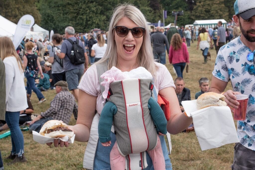 Smiling visitor enjoying the Alresford Show atmosphere
