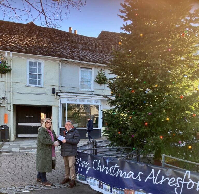 Jo Hemlsey handing cheque to Alresford Christmas Tree Fund